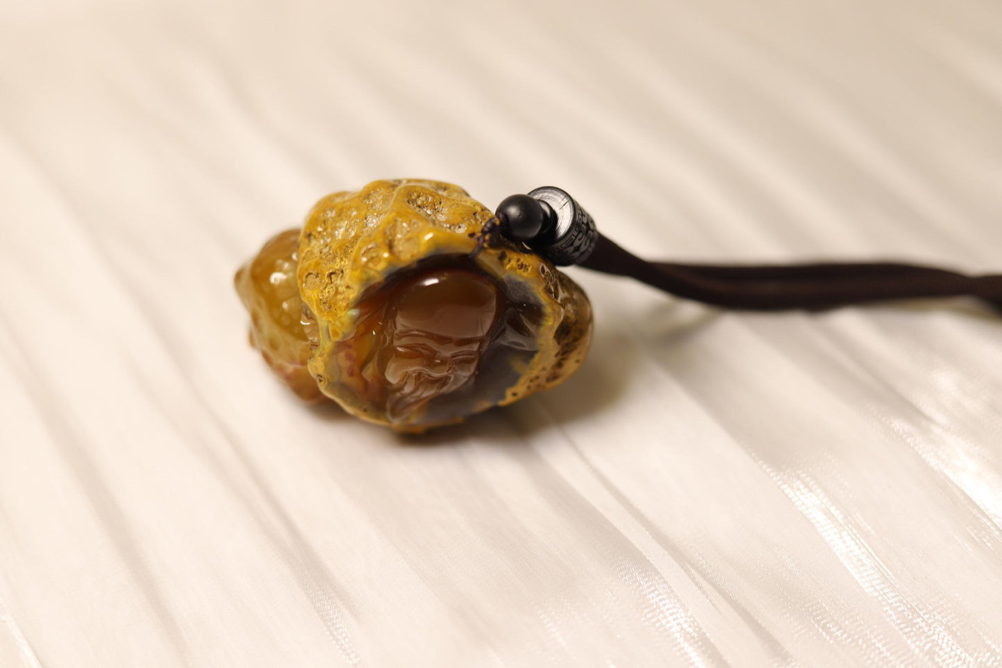 Hand-Carved Agate Pendant: Rustic Brown Sculpture, Polished Interior